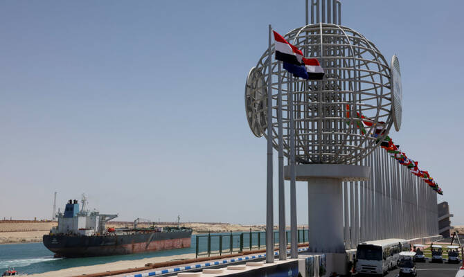 A ship moves through the Suez Canal, before a press conference in 