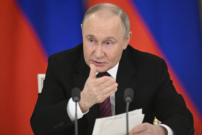 Russian President Vladimir Putin gestures as he speaks to journalists in the Grand Palace at the Kremlin in Moscow on May 11, 2025. (RIA Novosti photo via AP)