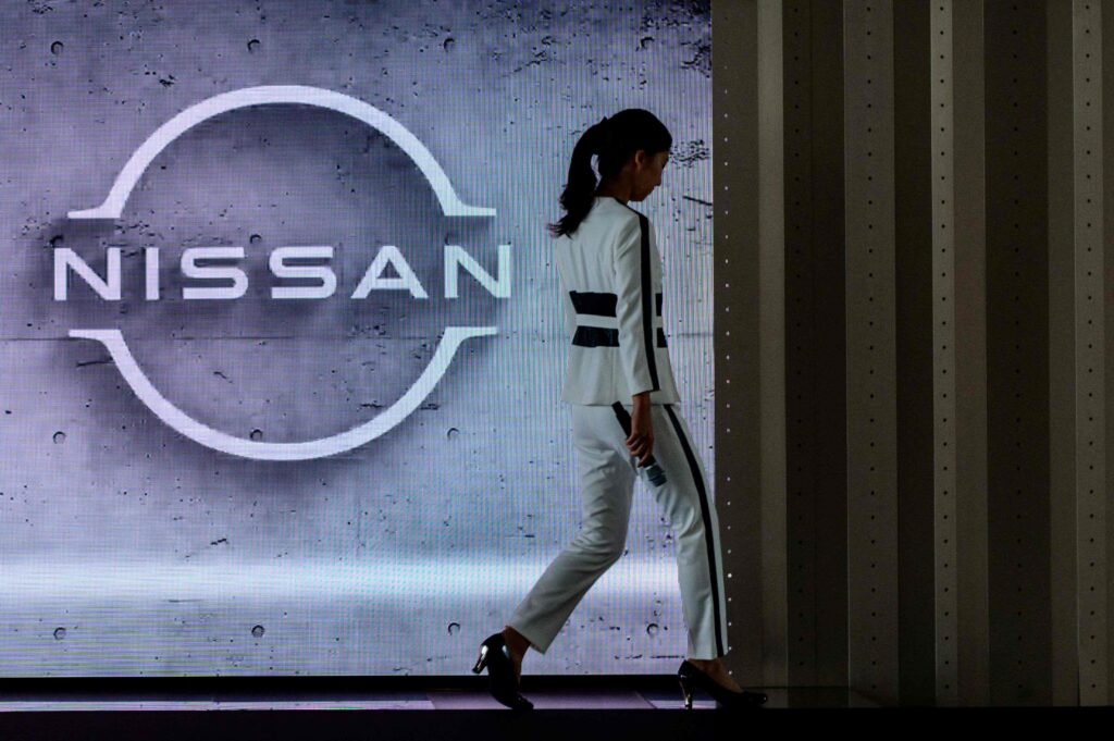 This file photo taken on July 28, 2020 shows a staff member walking off stage at the end of a presentation in the showroom at Nissan's global headquarters in Yokohama. Nissan plans to cut another 10,000 jobs worldwide, Japanese media reported on May 12, 2025, after the struggling carmaker said in November it would slash 9,000 positions. (AFP)
