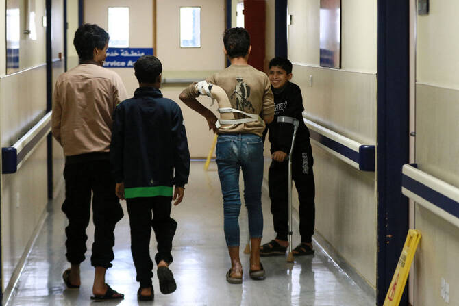 Young patients who sustained injuries in conflict zones walk along a corridor at the Al-Mowasah hospital in Amman on April 15, 2025. (AFP)