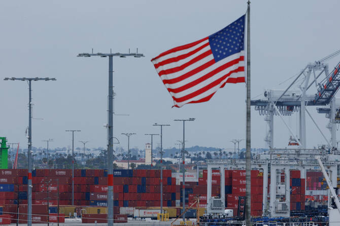 An American flag flutters near Chinese shipping containers at the Port of Los Angeles, in San Pedro, California, on May 1, 2025. (REUTERS)