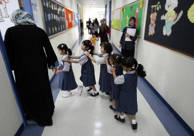 Students line-up as they ente their classroom on the first day of the academic year for schools in Dubai on September 27, 2009. (AFP)