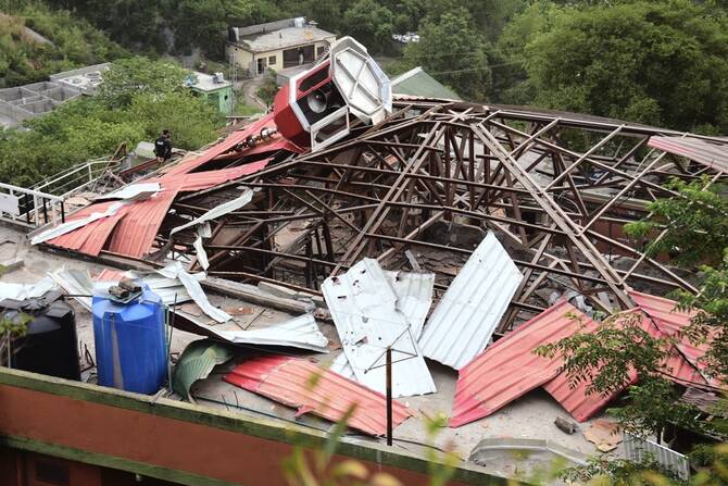 An army soldier stands guard on the rooftop of a mosque building damaged by a suspected Indian missile attack near Muzaffarabad. (AP)