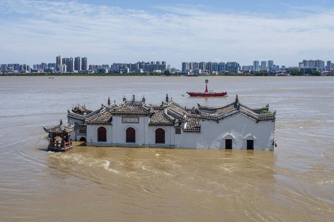 This photo taken on July 6, 2024 shows an aerial view of a partially submerged Guanyin temple in floodwaters in the swollen Yangtze River, in Ezhou, in central China's Hubei province. (AFP)