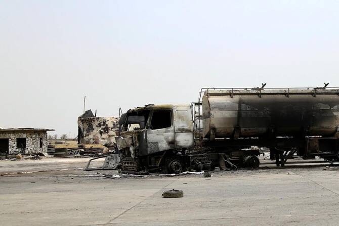 A charred tank truck stands at an oil storage facility after Israeli strikes in Yemen’s Houthi-held port city of Hodeidah, on July 25, 2024. (File/AFP)