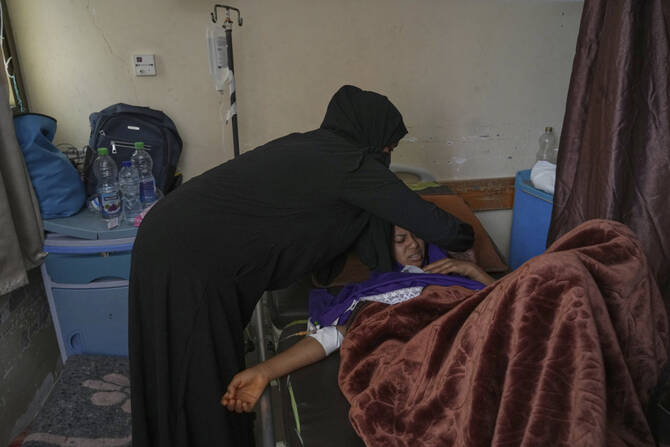 Salwa Faraj cares for her sister, Asmaa Faraj, who was injured in an Israeli army strike, at Nasser Hospital in Khan Younis, Gaza Strip, on May 6, 2025. (AP Photo/Abdel Kareem Hana)
