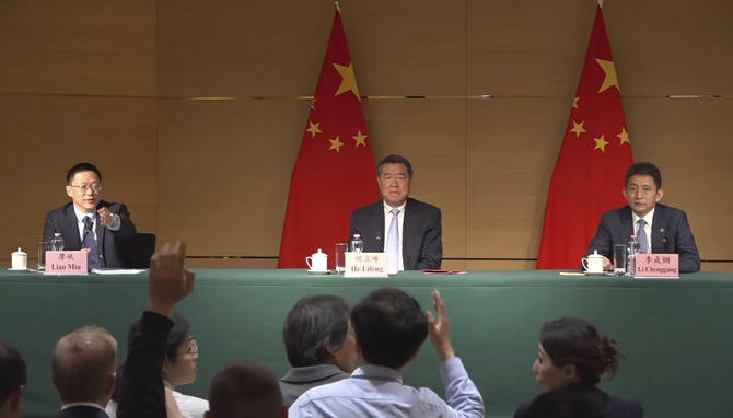China's Vice Premier He Lifeng (C), flanked by vice minister of finance Liao Min (L) and vice minister of commerce Li Chenggang, attend a news conference at the Chinese mission to the World Trade Organization in Geneva, Switzerland, on May 11, 2025. (AP Photo)
