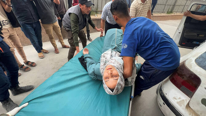 A wounded Palestinian woman is placed on a stretcher, after the European Hospital was partially damaged following Israeli airstrikes, according to the Gaza Health Ministry, at Nasser Hospital in Khan Younis, in the southern Gaza Strip, May 13, 2025. (Reuters)