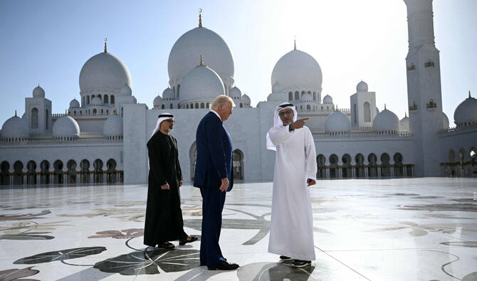 Yousif Al-Obaidli, director general of the Sheikh Zayed Grand Mosque, accompanies US President Donald Trump on a tour of the mosque in Abu Dhabi on Thursday. (AFP)