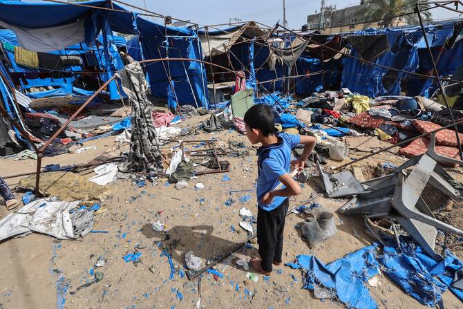 A Palestinian child stands in front of destroyed shelters following overnight Israeli airstrikes that reportedly hit tents for displaced Gazans outside the Al-Aqsa Martyrs hospital in Deir el-Balah in the central Gaza Strip, May 17, 2025. (AFP)