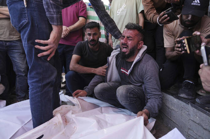 Osama Abu Mosabbah, mourns his wife and two children who were killed in an Israeli army airstrike on the Gaza Strip, during their funeral at Al-Aqsa Hospital in Deir al-Balah, Gaza, Tuesday, May 20, 2025. (AP)