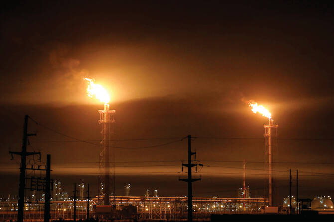 Gas flares at an oil refinery near Iraq’s receding marshes of Hawizeh, which straddle the border with Iran, in the southeastern Missan province. (AFP)