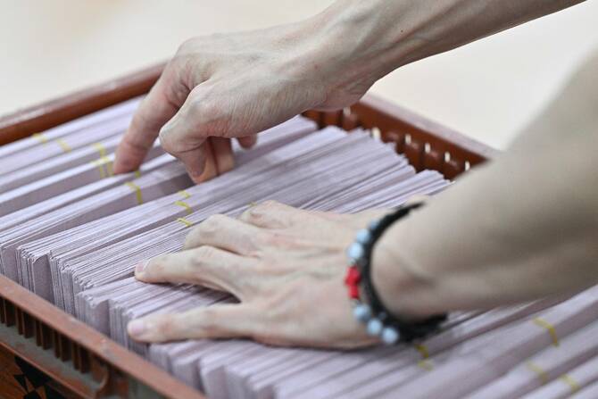 An official inspects the ballots submitted by South Korean citizens living abroad for the upcoming presidential election, at Incheon International Airport International Postal Logistics Center in Incheon, South Korea. (AFP)