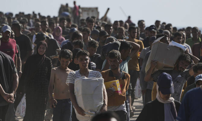 Palestinians carry boxes containing food and humanitarian aid packages delivered by the Gaza Humanitarian Foundation, a U.S.-backed organization approved by Israel, in Rafah, southern Gaza Strip, on Tuesday, May 27, 2025. (AP)
