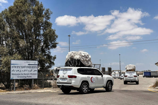 Vehicles, loaded with goods, enter the Kerem Shalom crossing between Israel and Gaza, on the Israeli side, on their way into Gaza on May 28, 2025. (Reuters)