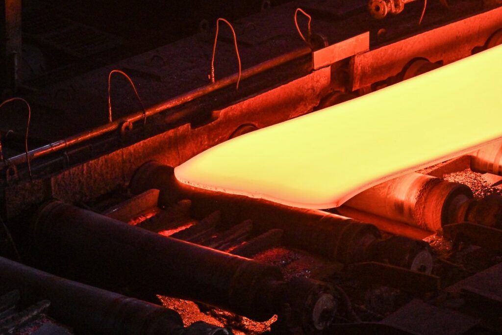 This general view shows steel moving along rollers at the hot rolling mill (rough rolling) during a media tour by Japanese company Nippon Steel at their East Nippon Works Kashima Area facility in Kashima, Ibaraki prefecture, north of Tokyo on December 6, 2024. (AFP)