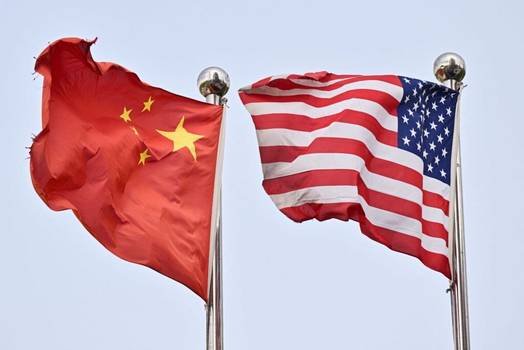 Chinese and US flags wave outside a technology company in Beijing on April 17, 2025. (AFP)