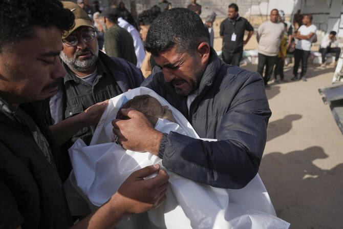 Mohannad Al-Agha, holds body of his niece Zeina Al- Agha, 2, killed in an overnight Israeli airstrike, during her funeral at Nasser Hospital in Khan Younis, Gaza Strip, Sunday, May 11, 2025. (AP)