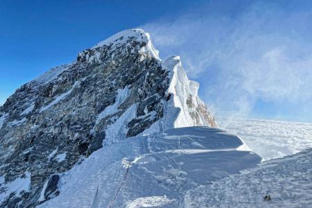 This photograph taken on May 31, 2021 shows mountaineers climbing the Hillary Step during their ascend of the South face to summit Mount Everest (8,848.86-metre), in Nepal. (AFP)