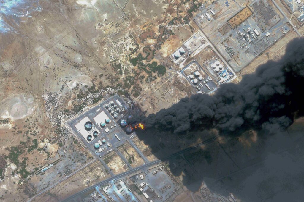 This handout satellite photo obtained from Planet Labs PBC and dated May 6, 2025, shows smoke billowing from a fuel storage depot after a strike on Port Sudan. (AFP)