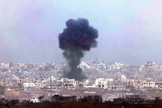 Smoke billows above destroyed buildings during Israeli bombardment in Gaza. May 27, 2025 (File/AFP)