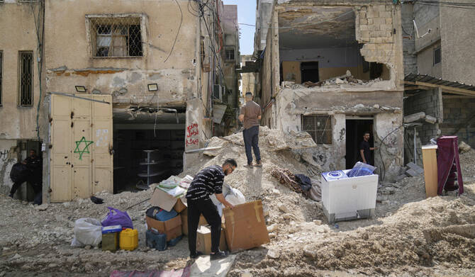 Residents of the now evacuated Palestinian refugee camp of Tulkarem return to collect belongings before the destruction of their homes as Israeli forces prepare to carry out the demolition of 116 homes across the two refugee camps of the Israeli occupied West Bank city of Tulkarem, Friday, May 2, 2025. (AP)