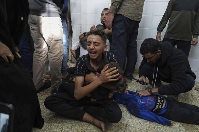 Mohammed Abed, center, mourns his sister Massa Abed, 4, who was killed in an Israeli army airstrike on the Gaza Strip, at the morgue of Al-Aqsa Hospital in Deir Al-Balah, Gaza, Apr. 27, 2025. (AP)