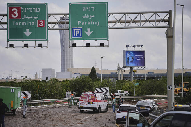 Israeli security forces inspect the site where the Israeli military said a projectile fired by Yemen's Houthi rebels landed in the area of Ben Gurion International Airport near Tel Aviv, Israel, on Sunday, May 4, 2025. (AP)