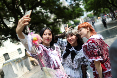 Japanese electro dancers Shirendev Oyun-Erdenen, known as Maaya the Bee, Emiko Kashiwazaki and Chiho Hidaka, take a selfie wearing clothes from the brand Chicanjuku, a fusion of Mexican-American Chicano culture and Japanese Harajuku style by Mexican designer Italia Segovia, 26, known as Kumiko, in Mexico City, Mexicom June 13, 2025. (Reuters)