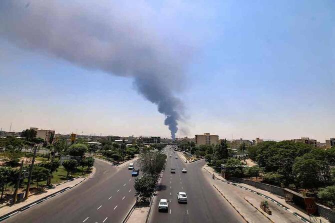 Heavy smoke and fire rise from an oil refinery in southern Tehran after it was hit overnight by Israel, on June 15, 2025. (AFP)
