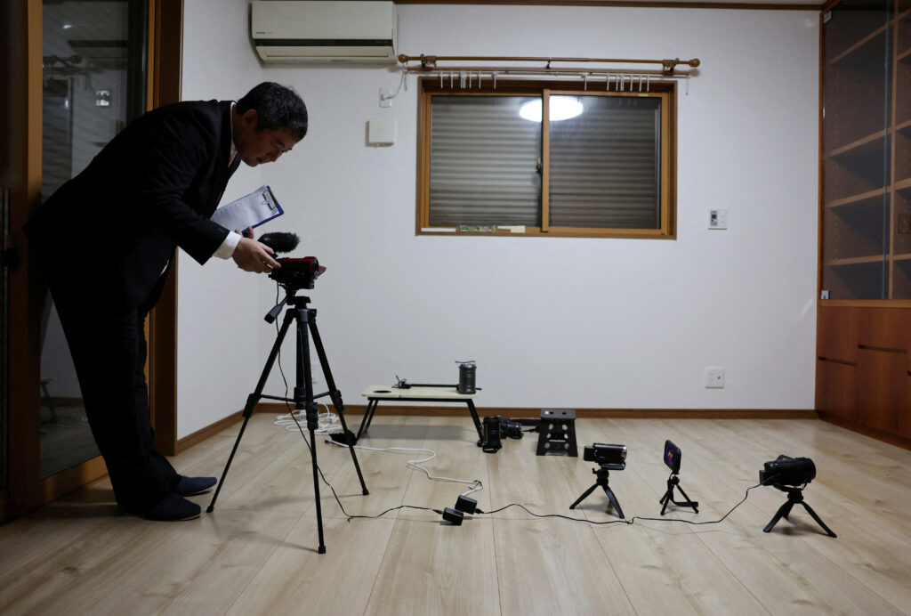 Real estate consultant Kazutoshi Kodama conducts a 'ghost investigation' at a house where an elderly woman had hanged herself seven years ago and her son died and went undiscovered for roughly 10 days last year, in Chiba Prefecture. (Reuters)
