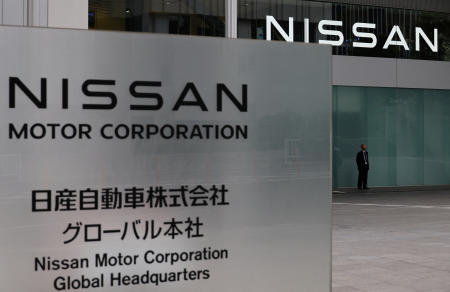 A man stands in front of the global headquarters of Nissan Motor while its annual shareholder meeting is being held in Yokohama, Japan, June 24, 2025.(REUTERS)