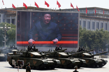 Chinese President Xi Jinping is displayed on a screen as Type 99A2 Chinese battle tanks take part in a parade commemorating the 70th anniversary of Japan's surrender during World War II held in front of Tiananmen Gate in Beijing on Sept. 3, 2015. (AP)