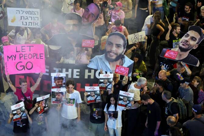 Demonstrators hold placards and portraits of Israeli hostages held in the Gaza Strip. (File/AFP)