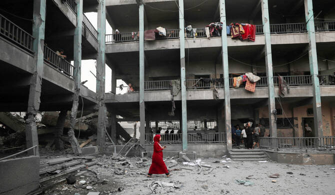 Palestinians inspect the damage at a school sheltering displaced people, following an Israeli strike, in Jabalia refugee camp, in the northern Gaza Strip, May 12, 2025. (REUTERS)