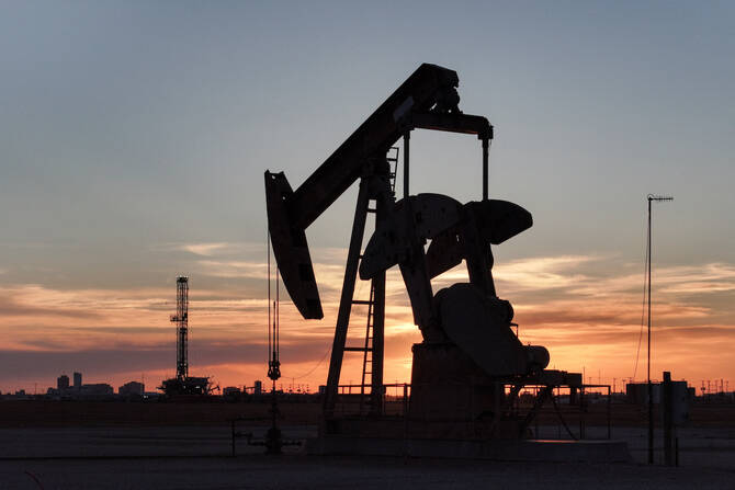 A drone view of a pump jack and drilling rig south of Midland, Texas, US, June 11, 2025. (Reuters)