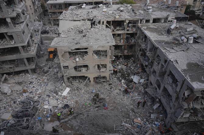 First responders work in a residential area hit by a missile fired from Iran near Tel Aviv, Israel. (AP)