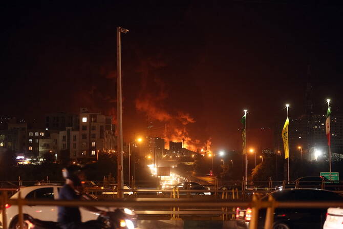 Fire and smoke rise from an oil warehouse in Tehran on June 15, 2024. (EPA)
