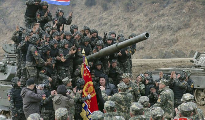 North Korean leader Kim Jong Un, center, meets soldiers who took part in a training in North Korea, on March 13, 2024. (AFP)