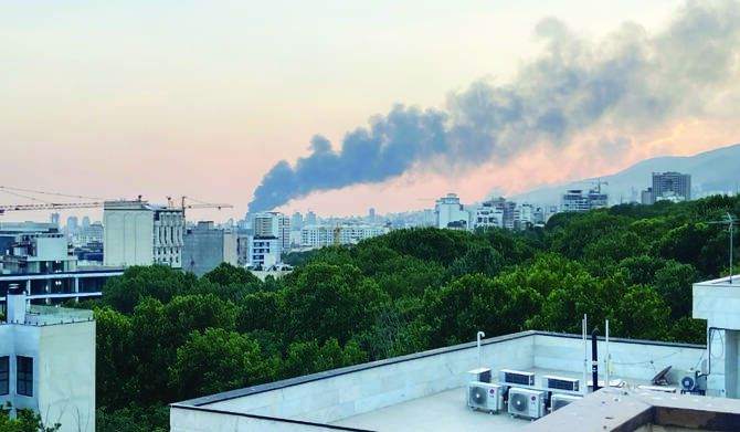 Smoke rises from the building of Iran's state-run television after an Israeli strike in Tehran, Iran, Monday, June 16, 2025. (AP)