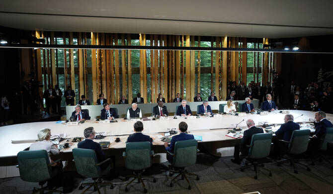 Canada's Prime Minister Mark Carney, back centre, chairs a meeting with world leaders and invited guests during the G7 Summit in Kananaskis, Alberta, Tuesday, June 17, 2025. (AP)