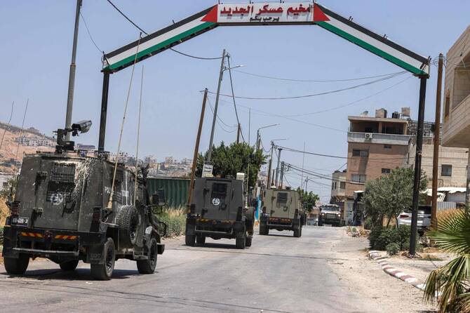 Israeli military vehicles drive into the Askar camp for Palestinian refugees east of Nablus in the occupied West Bank during a raid on June 16, 2025. (AFP)