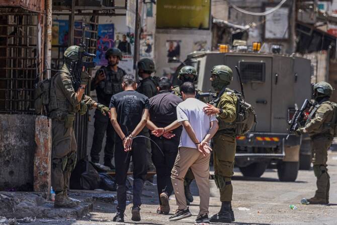 Israeli soldiers detain Palestinian men during a raid at the Balata refugee camp east of Nablus city in the occupied West Bank, June 18, 2025. (AFP)
