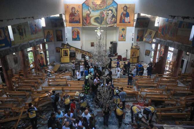 People and rescuers inspect the damage at the site of a reported suicide attack at the Saint Elias church in Damascus’ Dwelaa area on June 22, 2025. (AFP)