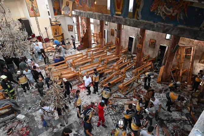 People and rescuers inspect the damage at the site of a reported suicide attack at the Saint Elias church in Damascus’ Dwelaa area on June 22, 2025. (AFP)