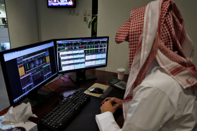 A Saudi trader observes the stock market on monitors at Falcom stock exchange agency in Riyadh, Saudi Arabia. File/Reuters