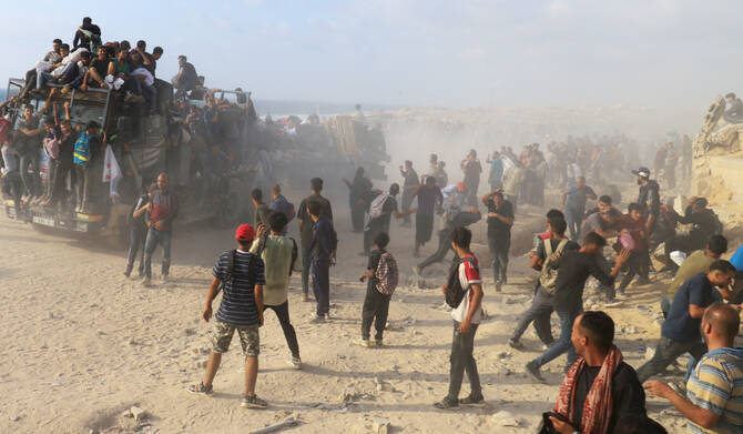 Palestinians gather to receive aid supplies in Beit Lahia, in the northern Gaza Strip, June 23, 2025. (REUTERS)