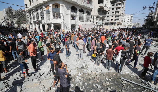 Palestinians inspect the site of an Israeli air strike on a house in Gaza City, June 27, 2025. (REUTERS)