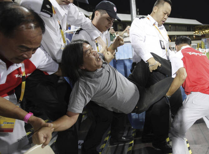 Hong Kong legislator Leung Kwok-hung is taken away by security guards during a protest on first day of Beijing Olympics Equestrian game in Hong Kong on Aug. 9, 2008. (AP file photo)