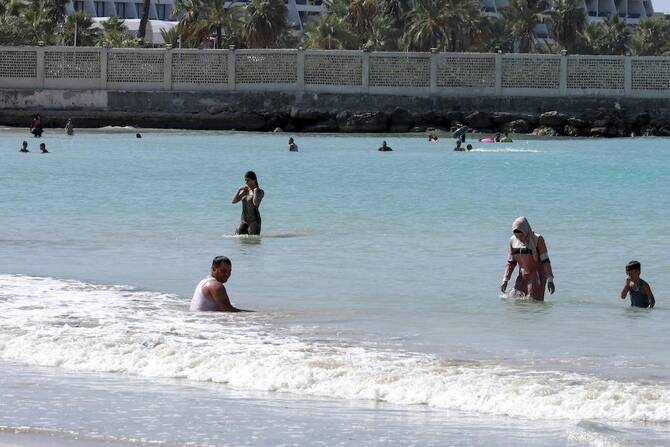 Above, Syrians spend time at the beach in the northern Mediterranean city of Latakia on Oct. 4, 2022. (AFP file photo)